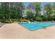 A large community pool with plenty of lounge seating, umbrellas, and a slide for added fun at 2026 Cresthaven Walk, Woodstock, GA 30189