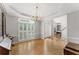 Elegant dining room with hardwood floors, tray ceilings, chandelier, and decorative trim at 2026 Cresthaven Walk, Woodstock, GA 30189