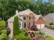 Traditional two-story brick home with well-manicured landscaping, a two-car garage, and a welcoming front entrance at 2026 Cresthaven Walk, Woodstock, GA 30189