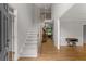 Inviting foyer with hardwood floors, staircase, and views into adjacent rooms, including a formal living space at 2026 Cresthaven Walk, Woodstock, GA 30189