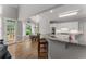 Open kitchen with breakfast bar, stainless appliances, and backyard views at 2026 Cresthaven Walk, Woodstock, GA 30189