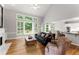 Spacious living room with hardwood floors, fireplace, and open to the dining area at 2026 Cresthaven Walk, Woodstock, GA 30189