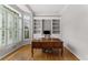 Bright office space with hardwood floors, custom shelving, and large windows with plantation shutters at 2026 Cresthaven Walk, Woodstock, GA 30189