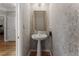 Stylish powder room featuring a pedestal sink and decorative wallpaper at 2026 Cresthaven Walk, Woodstock, GA 30189