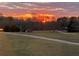 Exterior view of yard with an orange sunset in the background at 238 Marks Rd, Mansfield, GA 30055