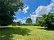 Lush green backyard with mature trees and a playset, perfect for outdoor activities at 238 Marks Rd, Mansfield, GA 30055