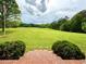 View of the expansive backyard from the brick stairs, surrounded by mature trees and lush greenery at 238 Marks Rd, Mansfield, GA 30055
