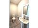 Cozy half bathroom with pedestal sink and square tile flooring at 238 Marks Rd, Mansfield, GA 30055