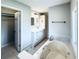 Bright bathroom featuring a soaking tub and white vanity at 238 Marks Rd, Mansfield, GA 30055