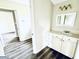 Bright bathroom featuring modern vanity, neutral walls, and gray flooring at 238 Marks Rd, Mansfield, GA 30055