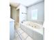Bright bathroom featuring a soaking tub and a separate shower space at 238 Marks Rd, Mansfield, GA 30055