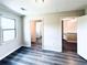 Bright bedroom with gray floors, two doorways, and a window letting in natural light at 238 Marks Rd, Mansfield, GA 30055