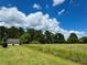 Exterior view of expansive green property with house and barn in distance at 238 Marks Rd, Mansfield, GA 30055