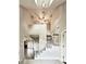 Elegant two-story foyer with a staircase, fan and modern chandelier at 238 Marks Rd, Mansfield, GA 30055