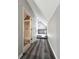 Hallway with plank flooring leading to bathroom and additional room with a built-in desk at 238 Marks Rd, Mansfield, GA 30055
