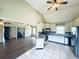 Bright kitchen with white cabinets and a vaulted ceiling connecting to the living area at 238 Marks Rd, Mansfield, GA 30055
