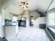 Spacious kitchen featuring white cabinets, stainless steel appliances, and a view of the staircase at 238 Marks Rd, Mansfield, GA 30055