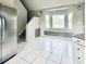 Sunny kitchen has a vaulted ceiling, stainless refrigerator, and corner windows with seating at 238 Marks Rd, Mansfield, GA 30055