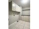 Practical laundry room with cabinets, countertop, and tiled floor at 238 Marks Rd, Mansfield, GA 30055