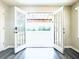 Open French doors lead to outdoor patio; gray floors add modern touch at 238 Marks Rd, Mansfield, GA 30055