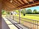 Spacious covered porch with views of the vast lawn and a charming red barn at 238 Marks Rd, Mansfield, GA 30055