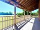 Covered porch offering serene views of the surrounding greenery and open space at 238 Marks Rd, Mansfield, GA 30055