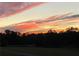 Scenic landscape showcasing a gorgeous sunset with orange and red clouds over a treeline at 238 Marks Rd, Mansfield, GA 30055
