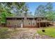 Rear exterior view of the house with a brick facade, deck, and large backyard at 2771 Smithsonia Way, Tucker, GA 30084