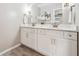 Bathroom featuring double sinks, modern fixtures, and bright white cabinetry at 2771 Smithsonia Way, Tucker, GA 30084