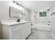 Bright bathroom featuring a sleek vanity, modern fixtures, and a shower with marble-style tiling at 2771 Smithsonia Way, Tucker, GA 30084