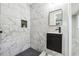 Modern bathroom showcases marble-tiled shower, sleek vanity, and elegant black fixtures at 2771 Smithsonia Way, Tucker, GA 30084