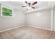 Comfortable bedroom showcasing a ceiling fan, neutral walls, and natural light from a window at 2771 Smithsonia Way, Tucker, GA 30084