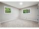 Bright bedroom with plush carpeting, neutral walls, and a pair of windows overlooking a lush, green landscape at 2771 Smithsonia Way, Tucker, GA 30084