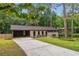 A cozy single-story home with lush greenery, a driveway, and a covered carport at 2771 Smithsonia Way, Tucker, GA 30084