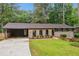 Charming single-story home with a well-manicured front yard and a covered carport at 2771 Smithsonia Way, Tucker, GA 30084