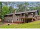 Back exterior view of house featuring a deck, brick facade, and spacious yard at 2771 Smithsonia Way, Tucker, GA 30084