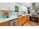 Charming kitchen features modern appliances, granite counters, and a view of the wooded property at 2771 Smithsonia Way, Tucker, GA 30084