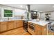 Open kitchen includes modern appliances, island seating, and flows seamlessly to the living room at 2771 Smithsonia Way, Tucker, GA 30084