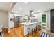 Bright kitchen boasts white cabinets, stainless appliances, and a large island with breakfast bar at 2771 Smithsonia Way, Tucker, GA 30084
