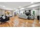 Open concept living and dining area with hardwood floors and a modern fireplace at 2771 Smithsonia Way, Tucker, GA 30084