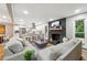 Open-concept living space with a fireplace, modern kitchen, and hardwood floors at 2771 Smithsonia Way, Tucker, GA 30084