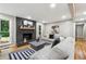 Cozy living room with a brick fireplace, comfortable seating, and bright lighting at 2771 Smithsonia Way, Tucker, GA 30084