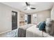 Main bedroom featuring a ceiling fan, stylish decor, and multiple doors at 2771 Smithsonia Way, Tucker, GA 30084