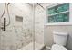 Modern shower showcasing marble tiling, a built-in niche, and a glass door at 2771 Smithsonia Way, Tucker, GA 30084