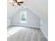Spacious attic bedroom with plush carpeting, lots of natural light, and neutral colored walls at 410 Hendon Rd, Woodstock, GA 30188