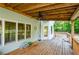 Back porch with wood flooring, white siding, and large windows with a view of the backyard at 410 Hendon Rd, Woodstock, GA 30188