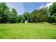 Expansive grassy backyard with mature trees, offering plenty of room for recreation and relaxation at 410 Hendon Rd, Woodstock, GA 30188