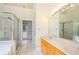 Bright bathroom boasts a double vanity, glass-enclosed shower, and an adjacent sunroom with exterior access at 410 Hendon Rd, Woodstock, GA 30188