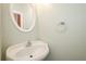 Powder room features a classic pedestal sink with a chrome faucet, a towel ring, and light-green walls at 410 Hendon Rd, Woodstock, GA 30188