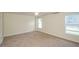 Spacious carpeted bedroom with natural light from two windows offers a comfortable and inviting atmosphere at 410 Hendon Rd, Woodstock, GA 30188
